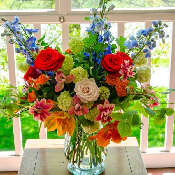 Bright and Colorful Flower Arrangement of Roses, Tulips, Spray Roses, Dahlias, and Delphiniums by Rebel Girl Floral