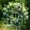 All white sympathy wreath perfect addition to a funeral service celebrating the life of a loved one.