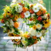 Open Heart Memorial Wreath with a mix of Yellow, White and Orange flowers and mixed greens.