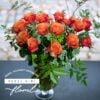 Beautiful bouquet of Orange roses with unique greens and accents arranged by Rebel Girl Floral