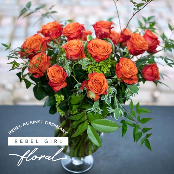 Beautiful bouquet of Orange roses with unique greens and accents arranged by Rebel Girl Floral