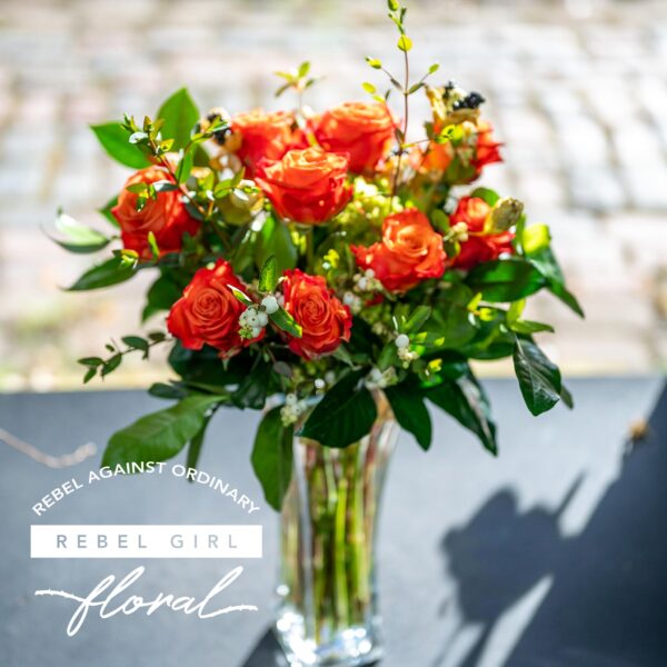 Beautiful bouquet of Orange roses with unique greens and accents arranged by Rebel Girl Floral