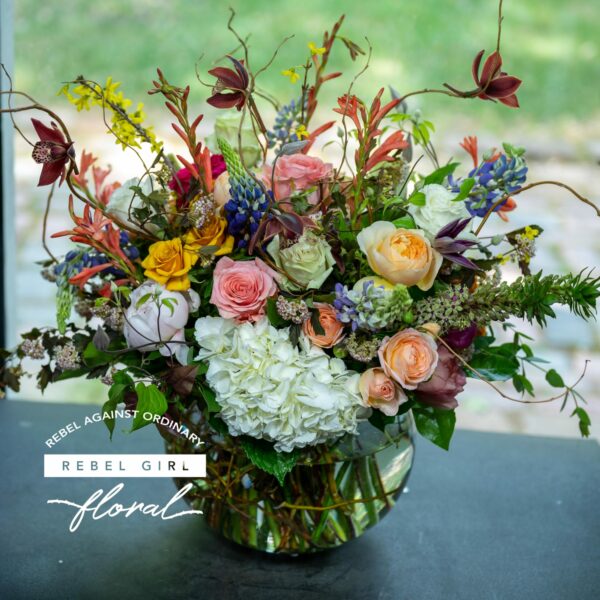 Vibrant and untamed Feral flower arrangement by Rebel Girl Floral, showcasing a wild blend of colorful premium blooms in a glass vase.